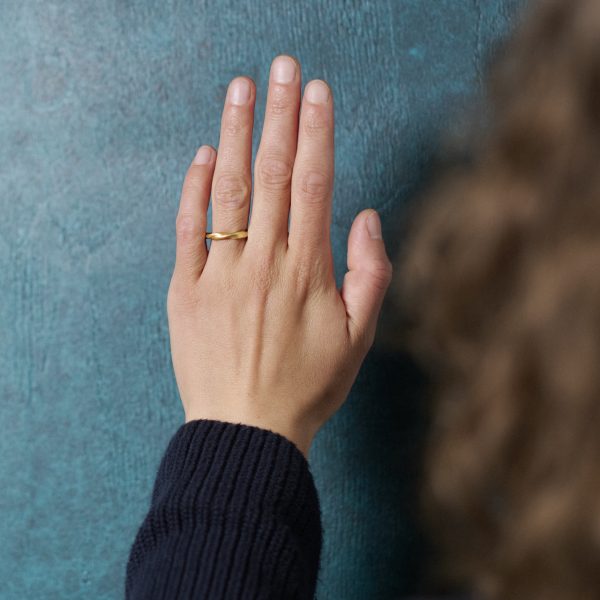 Gedrehter Ring in Gelbgold, getragen an Hand